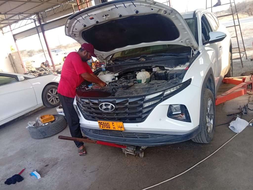 A Sial Kingdom technician servicing a car's air conditioning system at the Al Suwaiq branch in Oman.