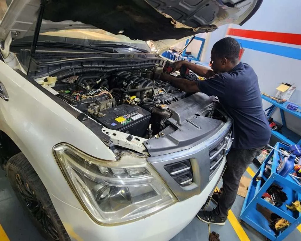 A Sial Kingdom technician working on a car engine at the Al Maabilah workshop in Muscat.