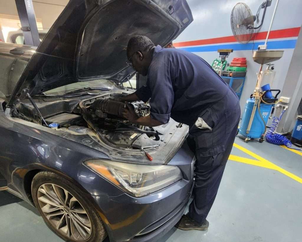 A Sial Kingdom technician inspecting engine components at the Al Maabilah workshop in Muscat.