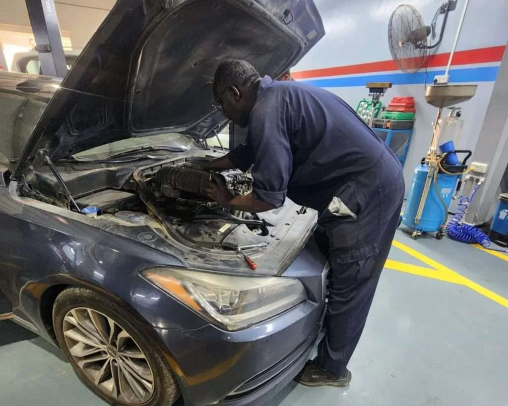 A Sial Kingdom technician inspecting engine components at the Al Maabilah workshop in Muscat.