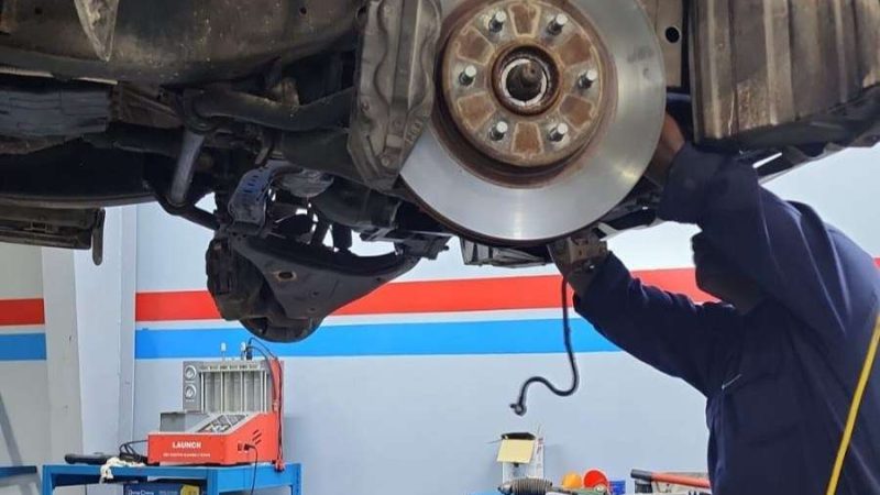 A Sial Kingdom technician working on a car engine in Muscat.
