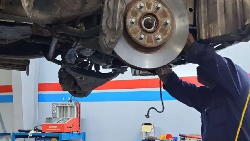 A Sial Kingdom technician working on a car engine in Muscat.