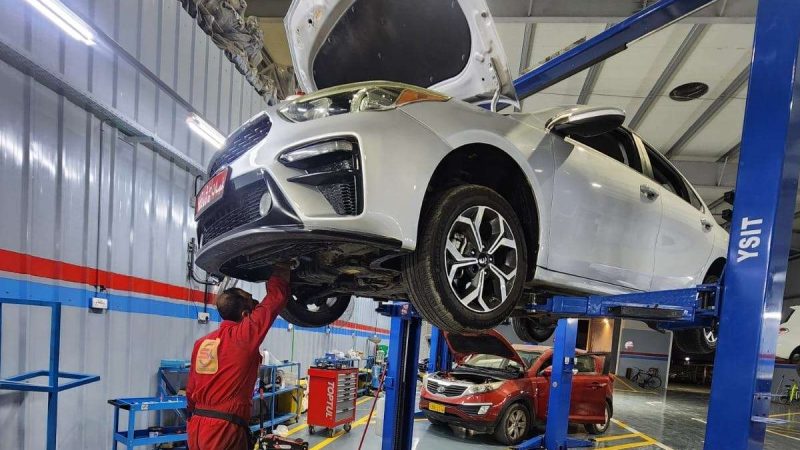 A Sial Kingdom technician inspecting a vehicle's brake components in Muscat.