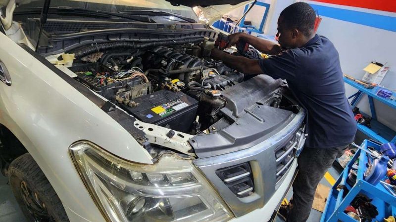 A Sial Kingdom technician working on a car engine at the Al Maabilah workshop in Muscat.