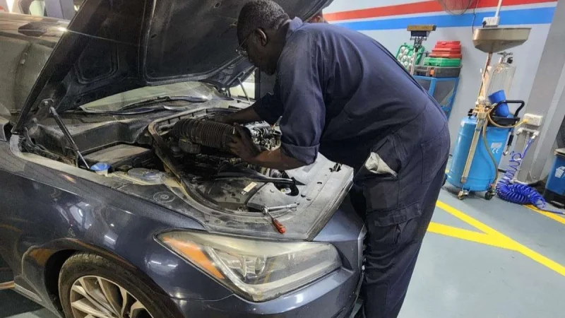 A Sial Kingdom technician inspecting engine components at the Al Maabilah workshop in Muscat.